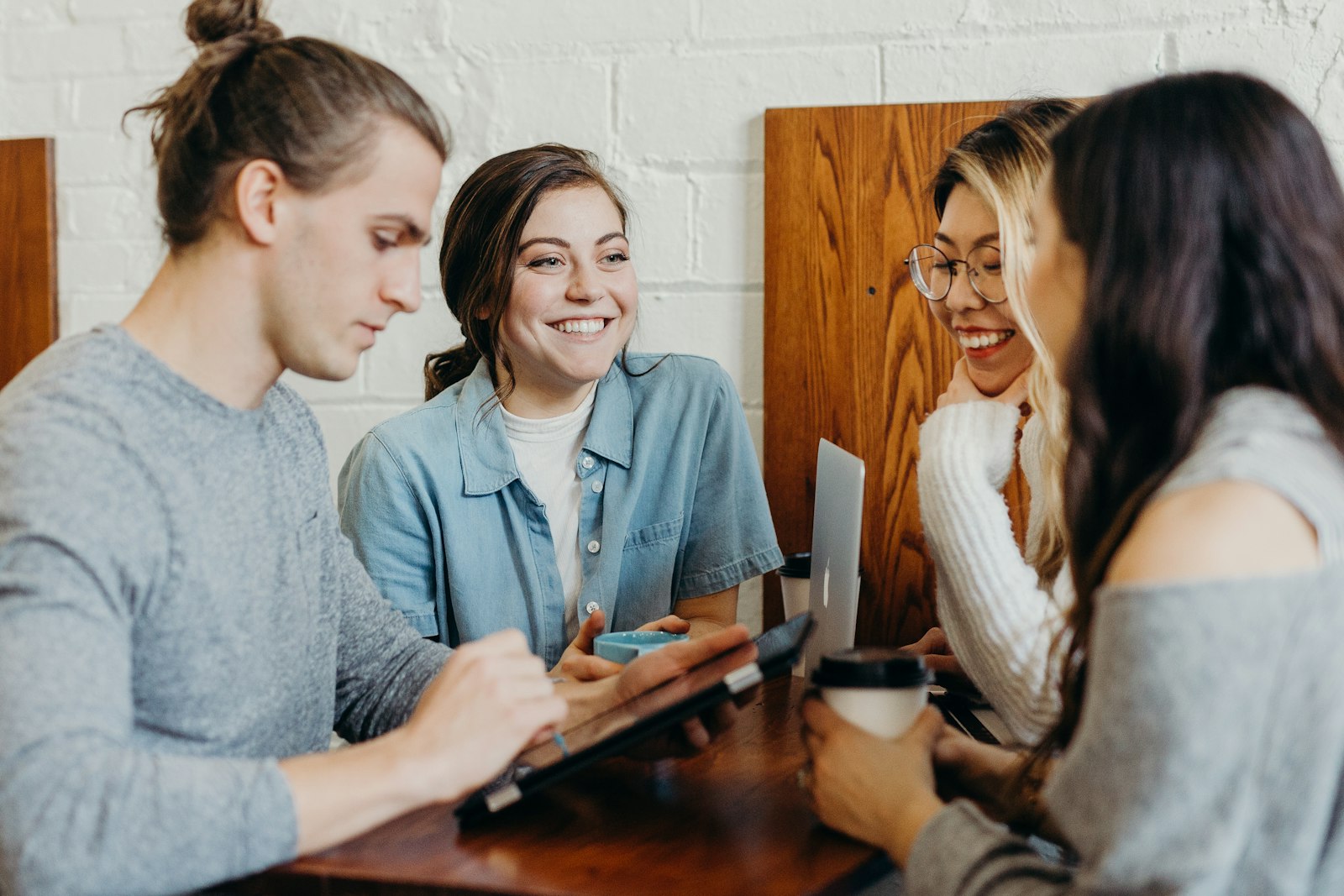 Four people talking at an evening gathering